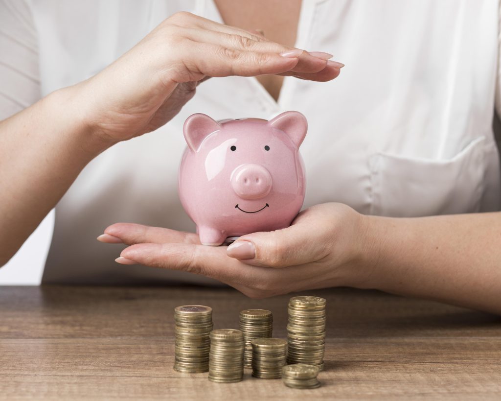 Piggy bank with piles coins