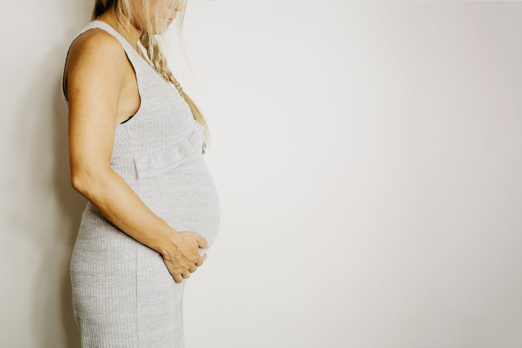 Pregnant woman touching belly
