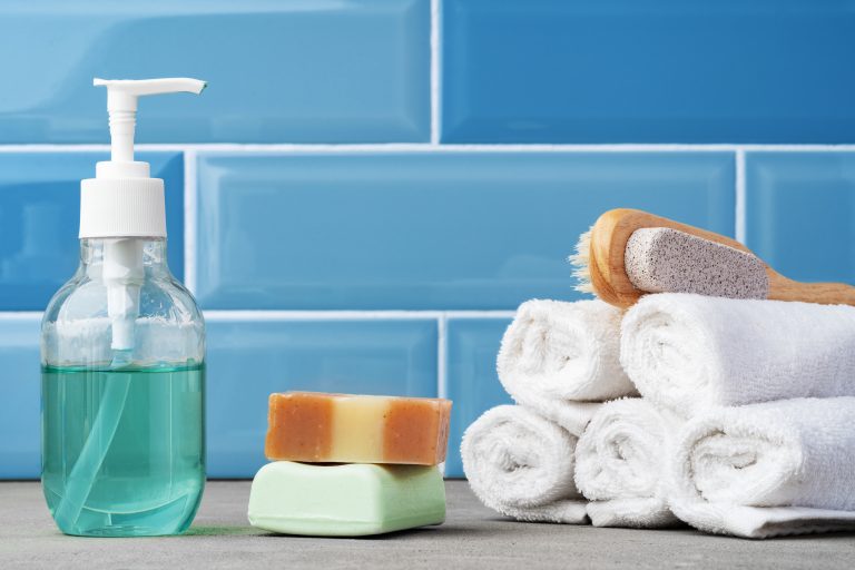 Soap and toiletries on shelf in blue bathroom