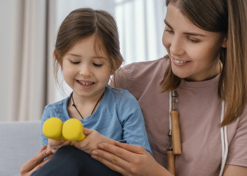 Close up girl holding dumbbells