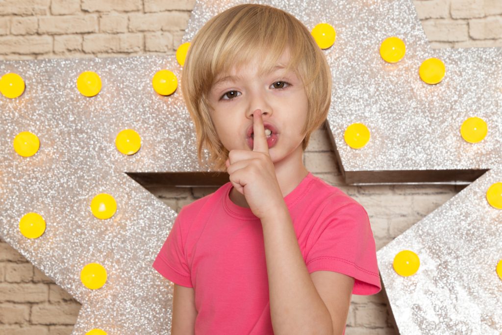 Front view cute little kid pink t shirt grey jeans star designed yellow stand light background (3)