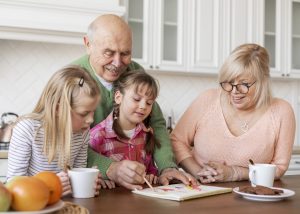 Medium shot grandparents girls indoors
