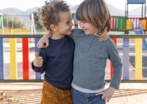 Little boys outdoors hugging