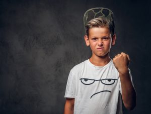 Portrait of funny cheeky hooligan at photo studio