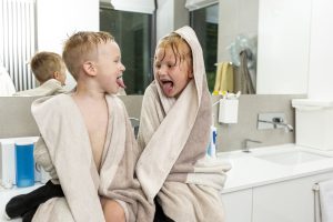 Medium shot children sitting bathroom