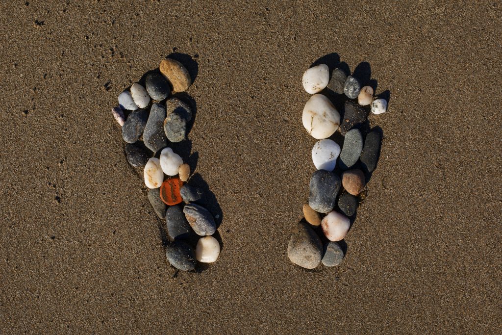 View beach sand summertime with footprints stones