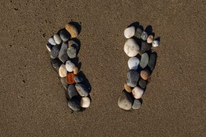 View beach sand summertime with footprints stones