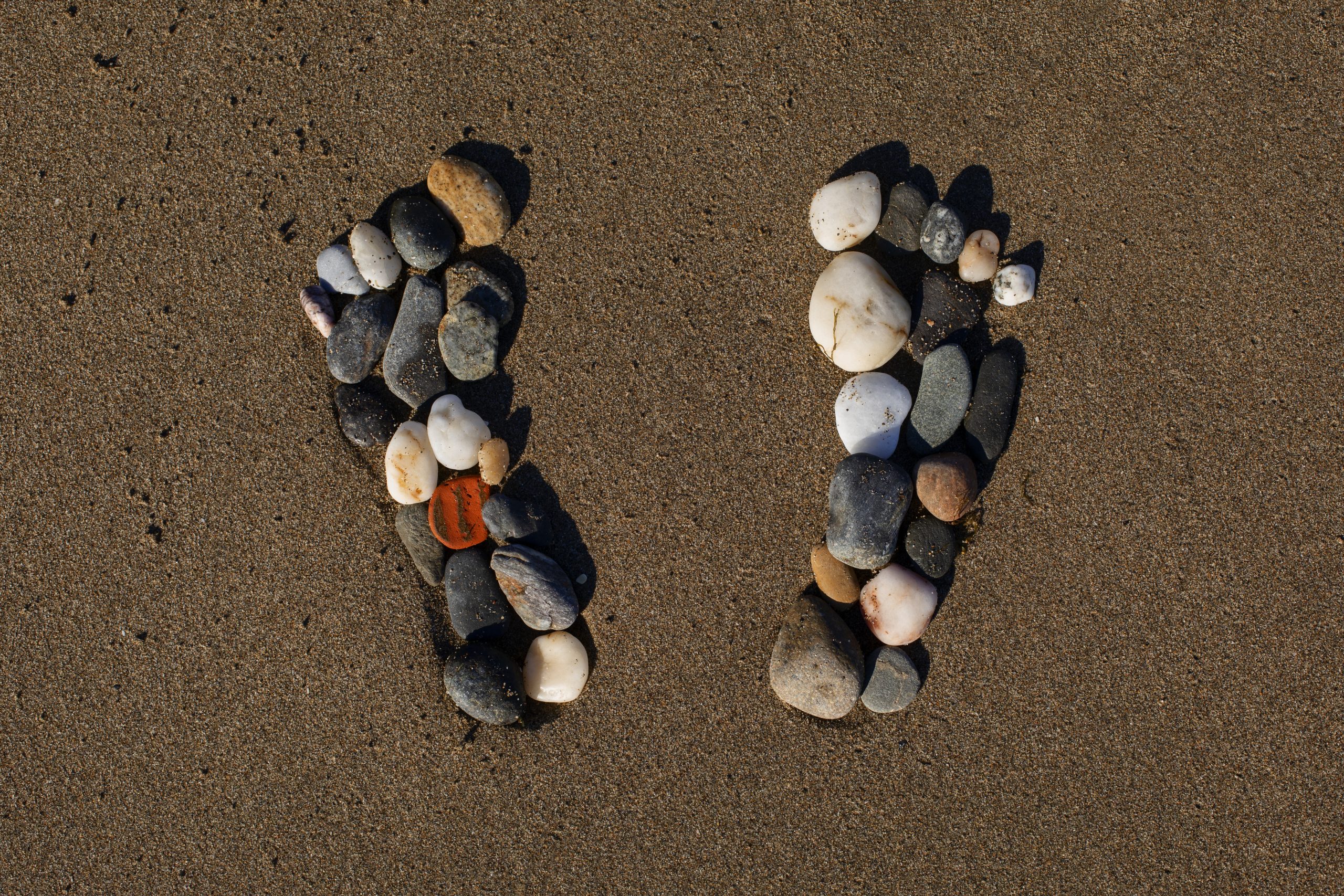 View beach sand summertime with footprints stones